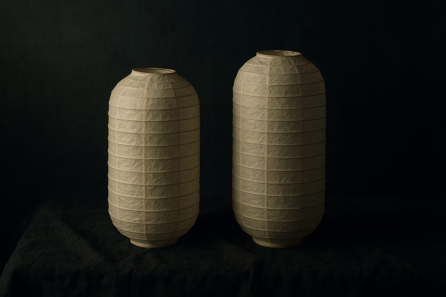 Decorative still-life of two tall unlit paper lanterns