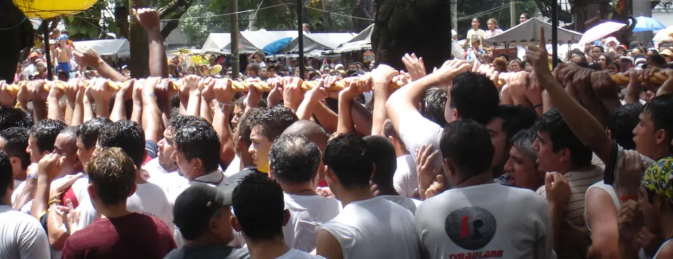 Hands raised to grip the procession rope at the Círio de Nazaré in Belém