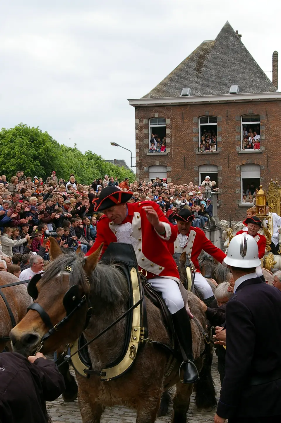 Riders in red coats and tricorne hats in the Lumeçon combat on the Grand-Place of Mons, 2008