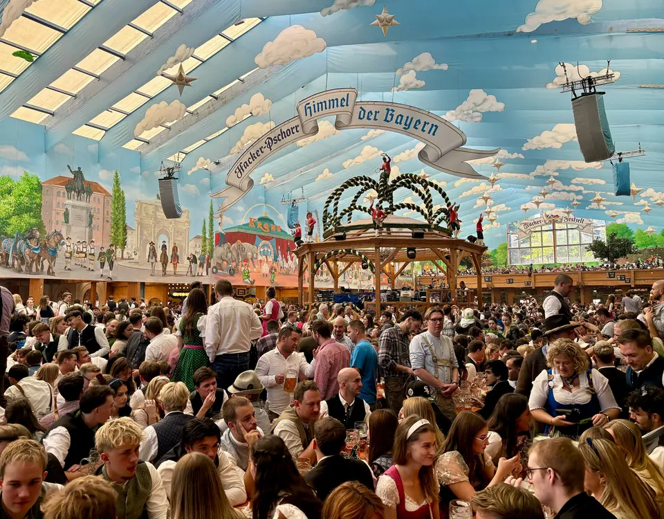 A packed Hacker-Festzelt under its painted sky ceiling, Oktoberfest 2025